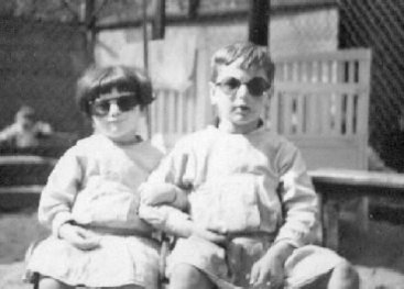Two children wearing sun glasses.